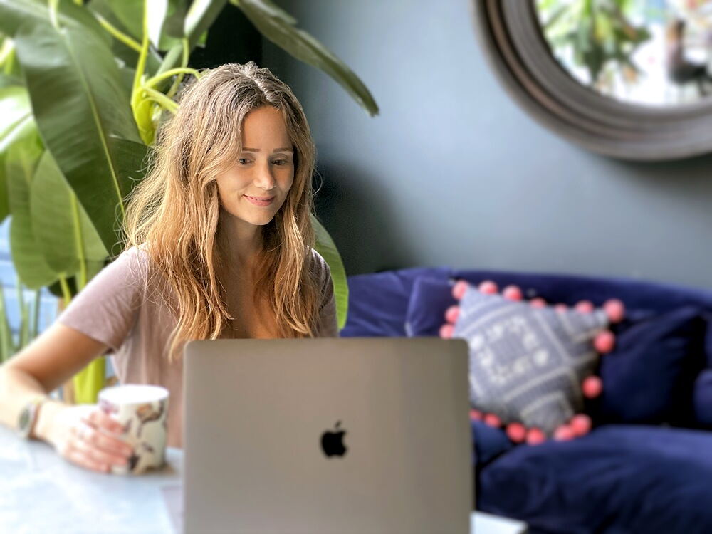 Susannah Saunders at home with her laptop