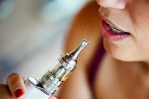 give up vaping, woman using an e-cigarrette