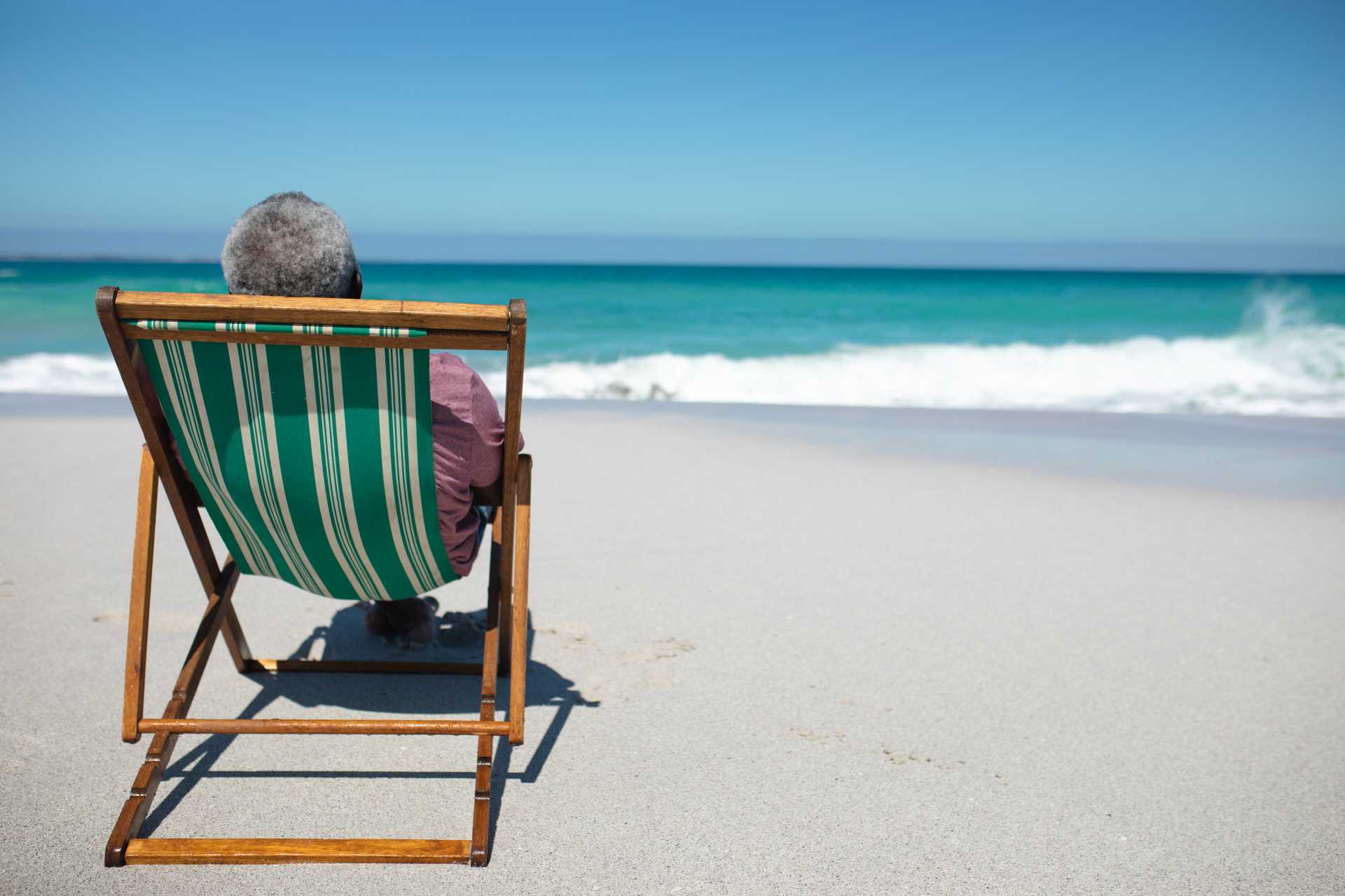 anxiety over retirement, An old man relaxing on a chair at the beach.