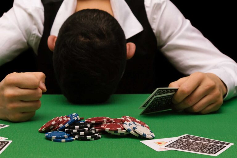 cost of gambling addiction, A man distressed over losing a game.