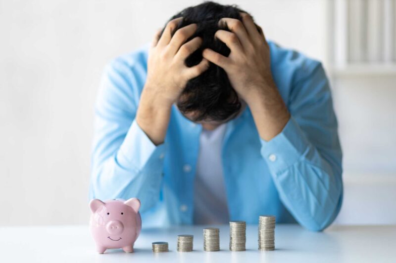 cost of living anxiety, A man in despair over personal finances.