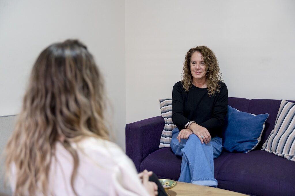 high functioning depression and anxiety, Woman sitting on the sofa while having a therapy session in the psychologist office.