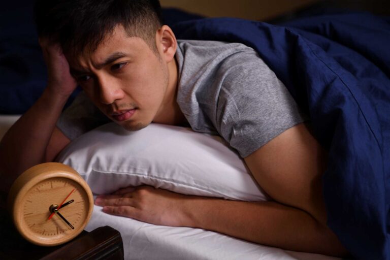 how to help sleep anxiety, A man sleepless in the middle of the night.